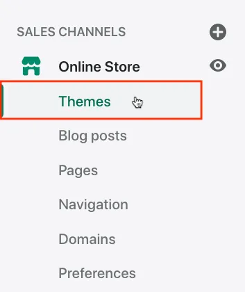 The left menu of the Shopify admin under SALES CHANNELS. Online Store is expanded, with the entries Themes, Blog posts, Pages, Navigation, Domains and Preferences under it. Themes is framed in red, and the pointer rests on it. Selecting Themes opens the page with your current theme, where you find Edit code. The plus next to SALES CHANNELS and the eye next to Online Store are Shopify's own controls and are not needed for the chat.